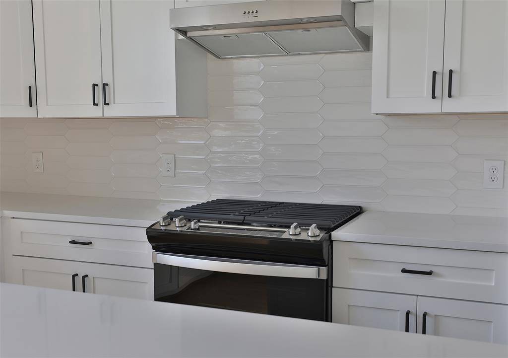 Take in the view from above your kitchen sink, complemented by 12x3 glossy white subway picket tiles.