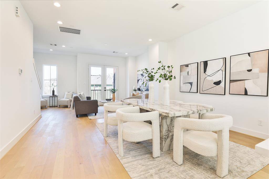Picture yourself dining with friends and family in this spacious, open second-floor living area. To the right, a dry bar with ample storage is perfect for your decor, dishes, and more.