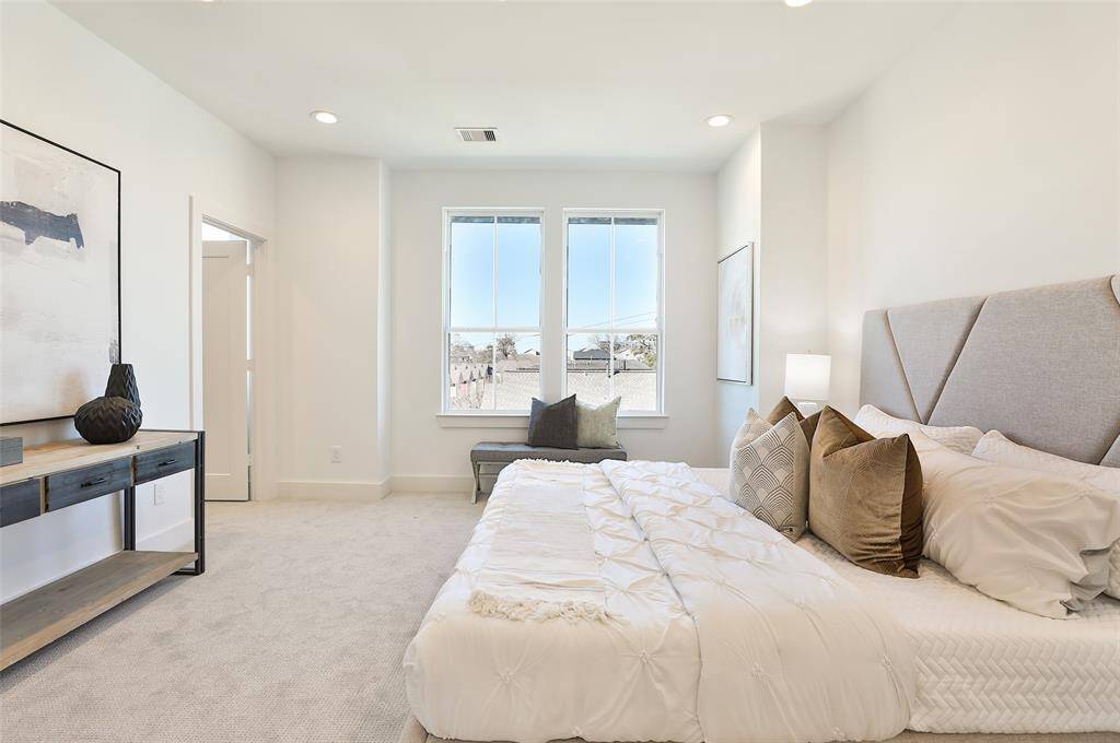 Primary suite complemented by windows that surround the space. Large walk in closet to the left with windows as well to let in natural light.
