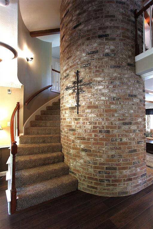 Spiral staircase has a stunning brick focal point