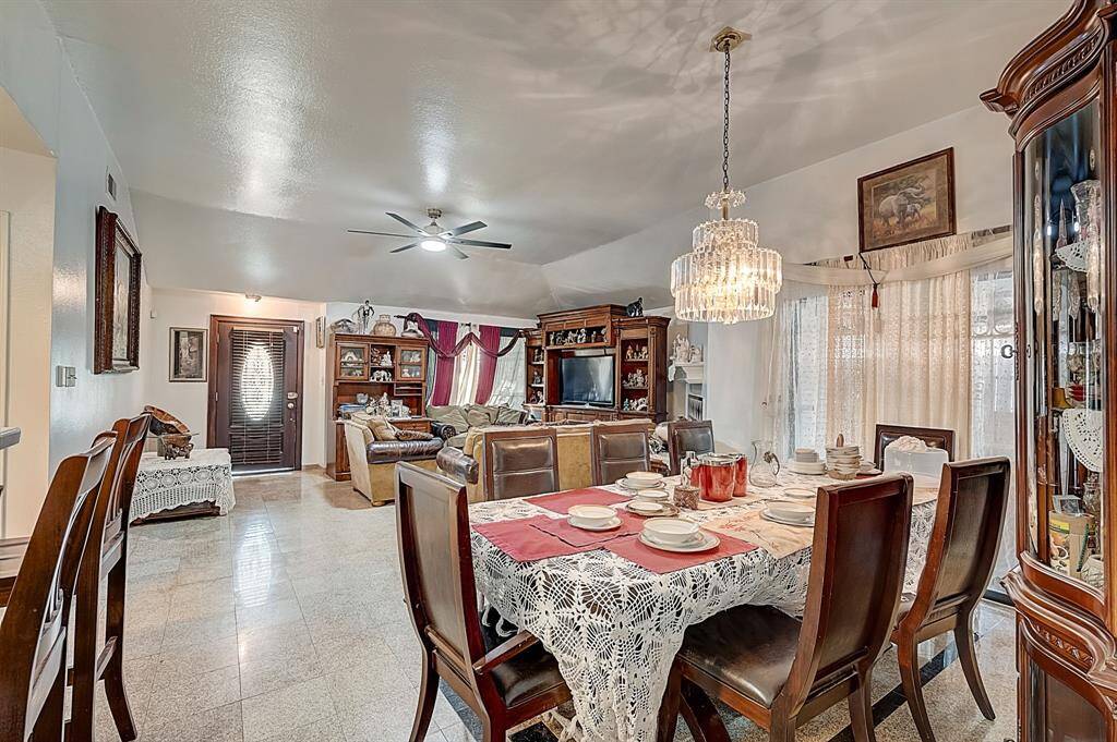 Dining area with exit door to the back yard behind courtains.
