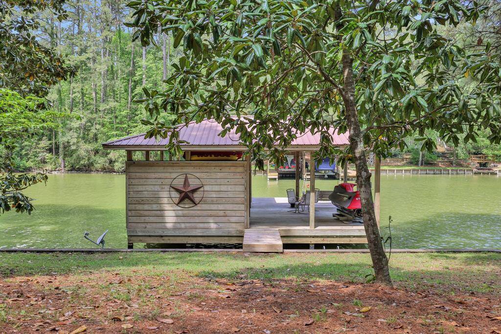 The boathouse has a seating area, boat lift and jet ski lift
