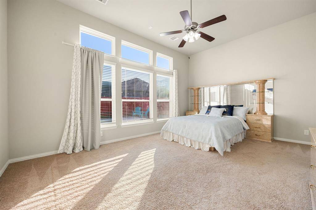 What a wonderful place to come home to, this stunning primary suite greets you with plush carpet floors, ceiling fan with lighting, lovely windows with blinds, bathed in lot of natural sunlight