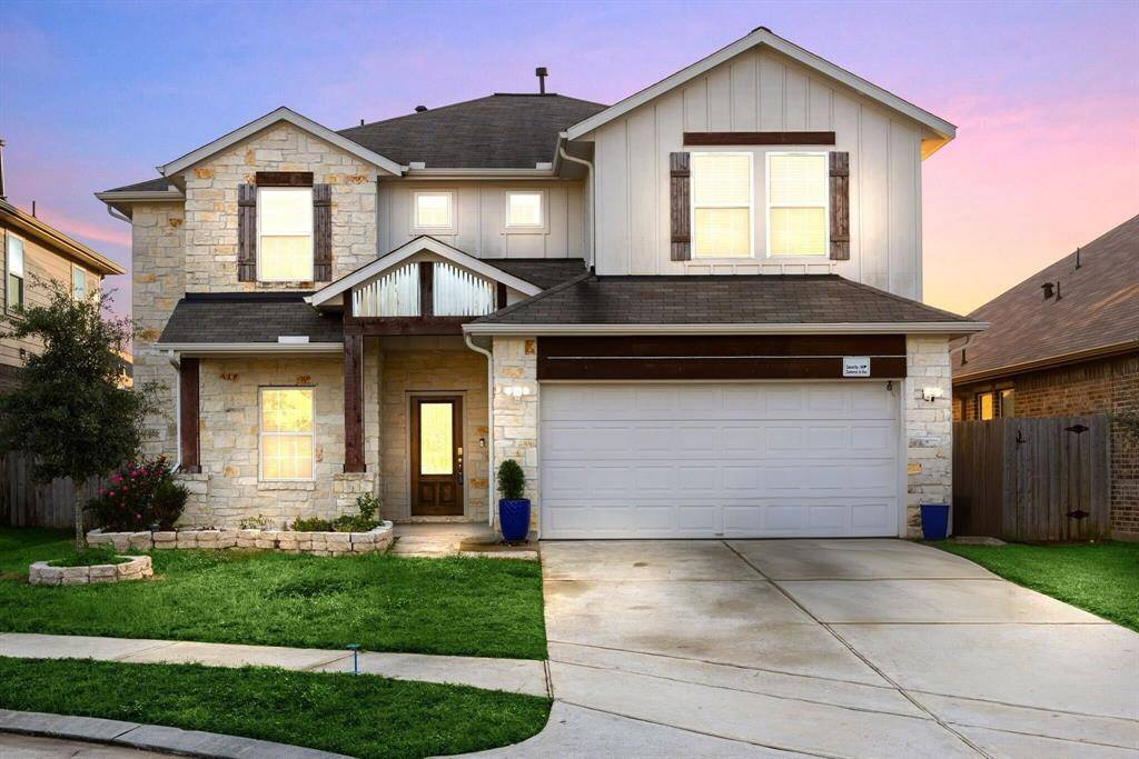 Lovely curb appeal, a well-manicured lawn, beautiful landscaping, modern style with luxury stone!