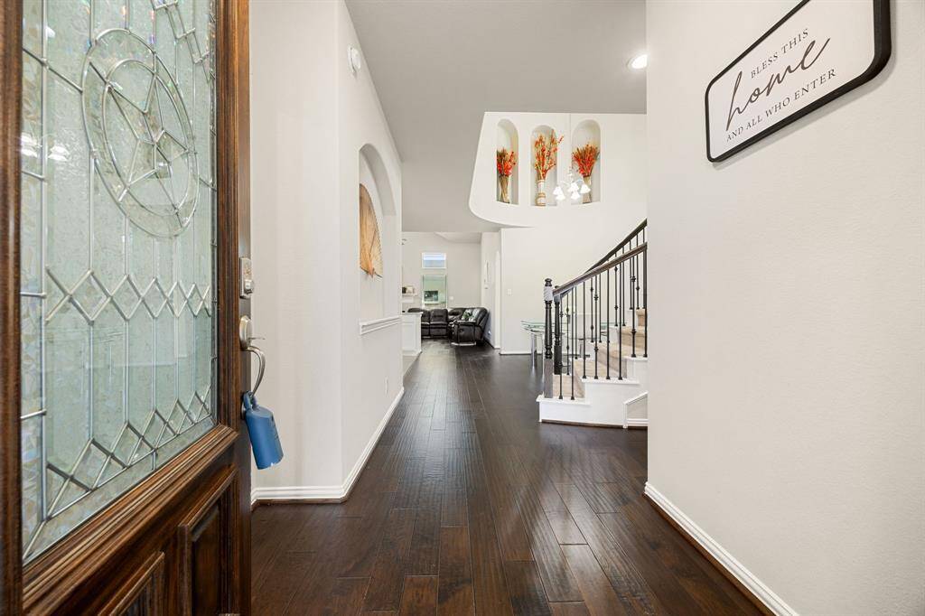 A long hallway leading to spacious living room.