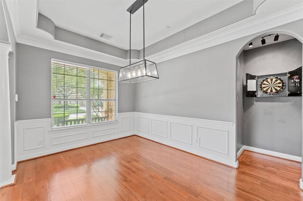 Elegant tray ceilings and a unique dart area make this space perfect for entertaining and formal meals.