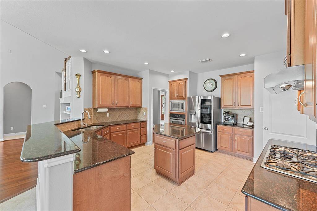 This chef’s kitchen is equipped with high-end stainless steel appliances, ready to handle everyday meals and special occasions alike.