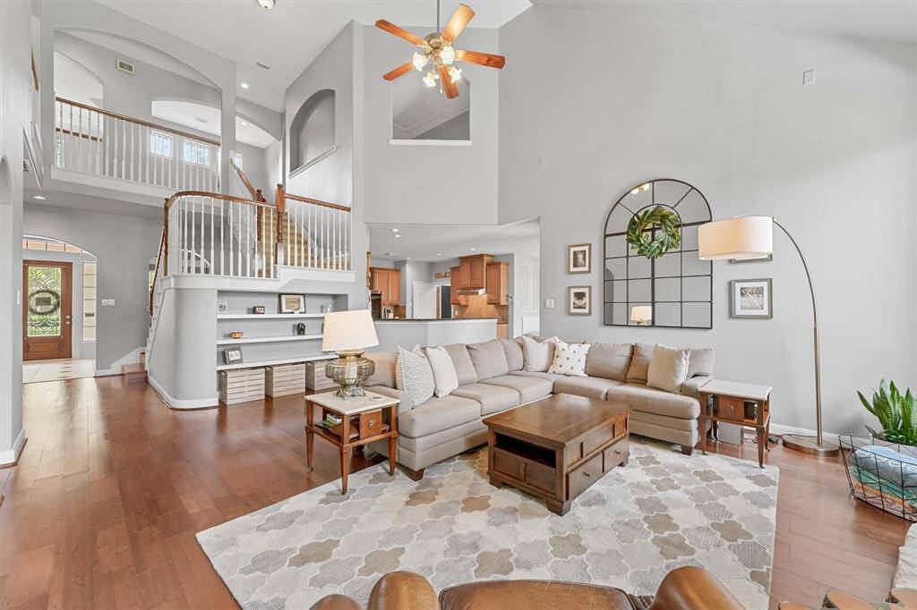 This expansive living area has soaring ceilings, built-ins for seamless storage, and an open, airy feel.