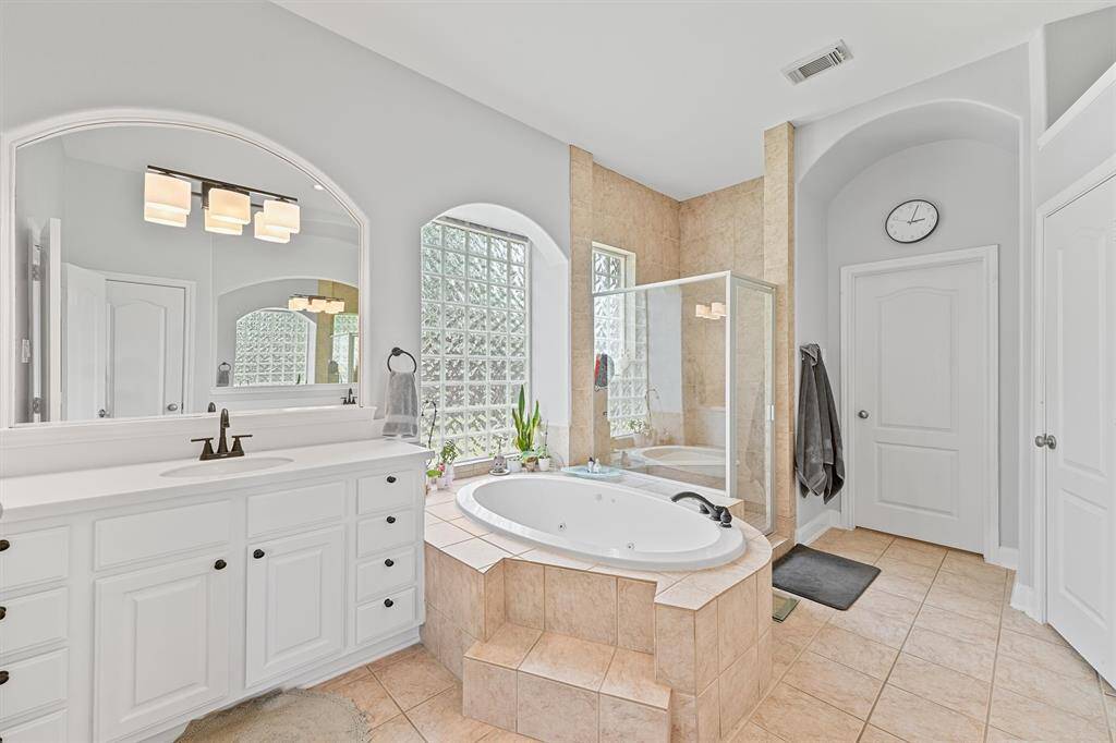 The spa-like primary bathroom has a jetted soaking tub and separate walk in shower for ultimate comfort.