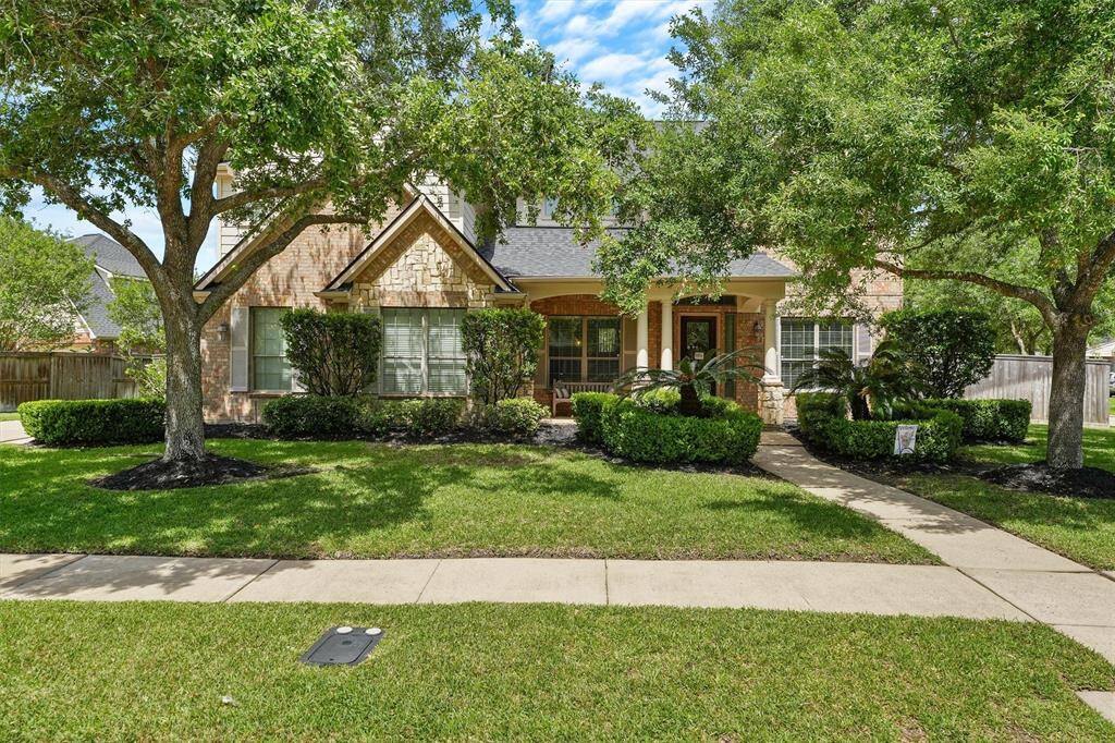 Charming exterior with manicured landscaping, lush greenery, and timeless architectural details—true curb appeal that makes a lasting first impression.