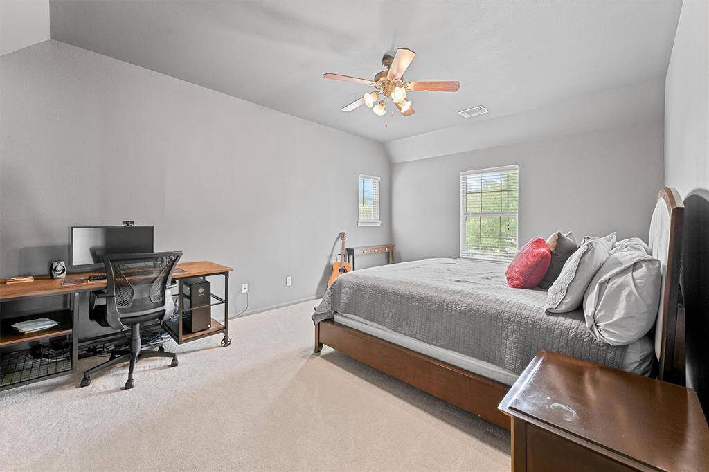 Well-sized bedroom with plush carpet and a welcoming atmosphere for restful nights.
