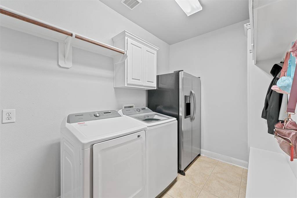 Spacious downstairs laundry room offering flexibility and extra room for an additional fridge or freezer.
