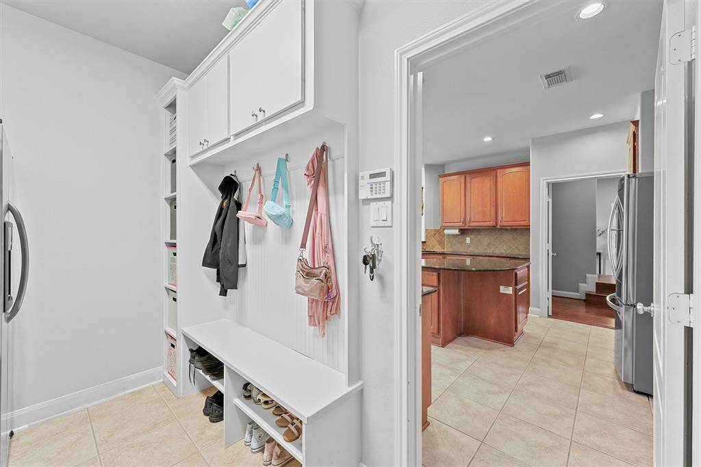 Built-in cabinets and shelving maximize laundry room functionality.