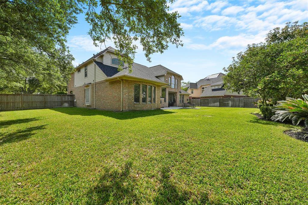 A spacious backyard with plenty of room to play or garden.