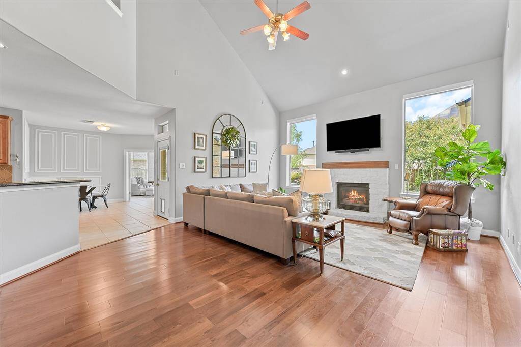 This warm and inviting living space is centered around a gorgeous white brick fireplace—perfect for cozy evenings or entertaining guests.