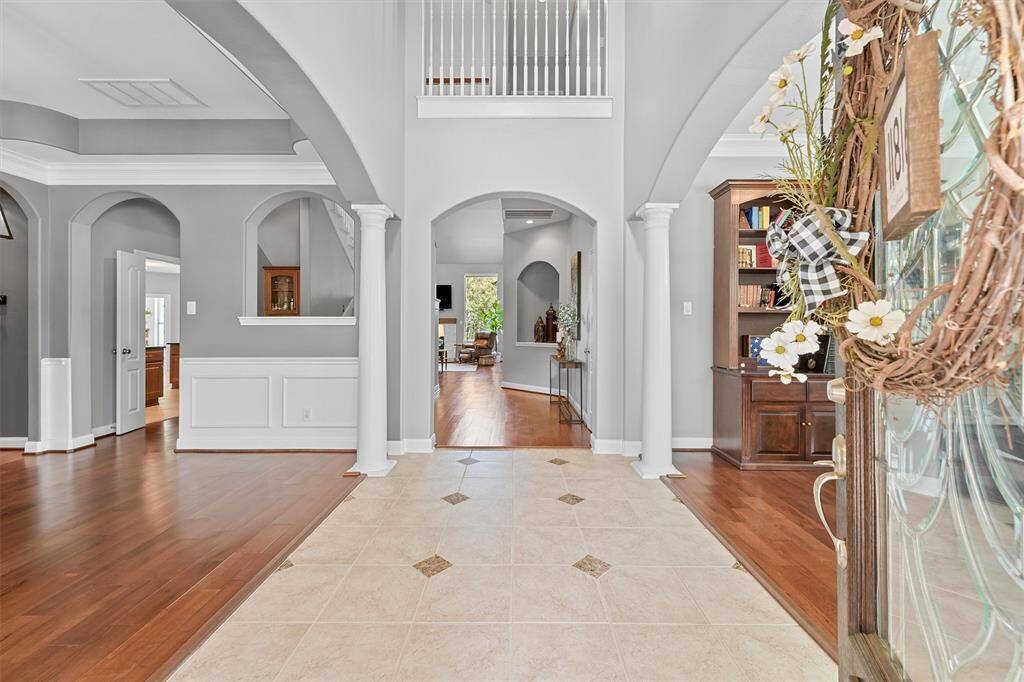 Now that we have seen a few highlights let's take a closer look around. This grand entrance with high ceilings, elegant white columns, and abundant natural light sets a luxurious tone and you step inside.