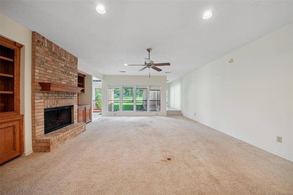 Sizable living room with cozy gas log fireplace.