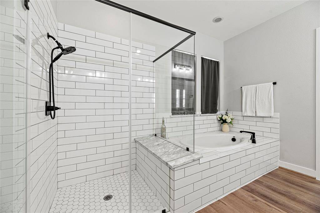 The stylish oversized walk-in shower with beautiful tile work and glass front.