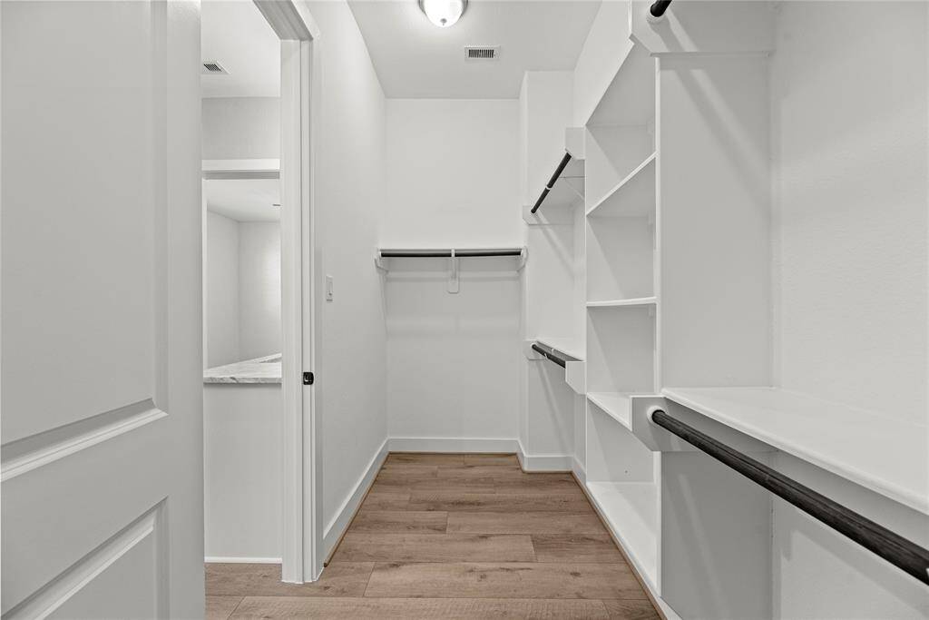 The primary walk-in closet has room for all the clothes.