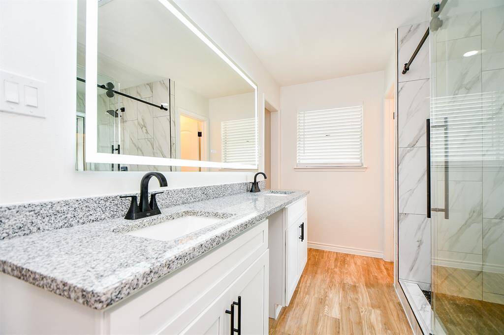 Master Bathroom with double vaity and walk in shower with double shower head.