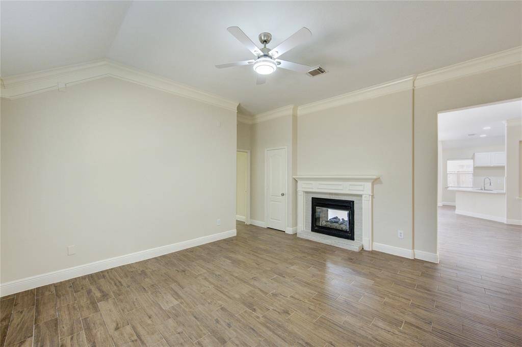 Den connecting to living room with fireplace