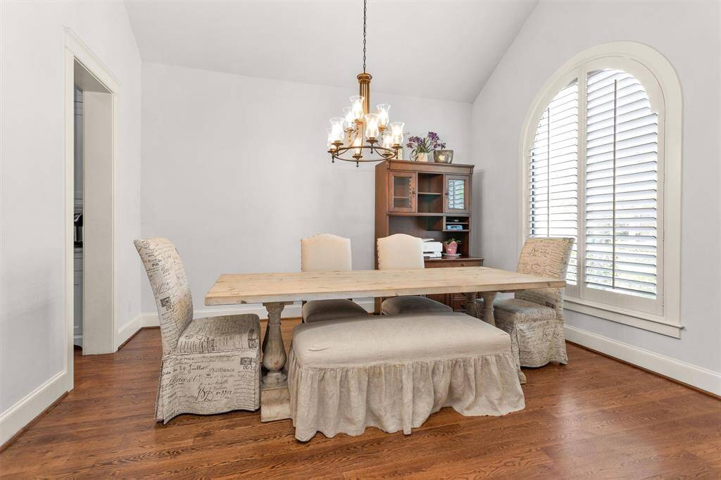 Host unforgettable dinners in the sophisticated formal dining room with tile floors, crown molding, and easy flow to the kitchen and main living spaces.