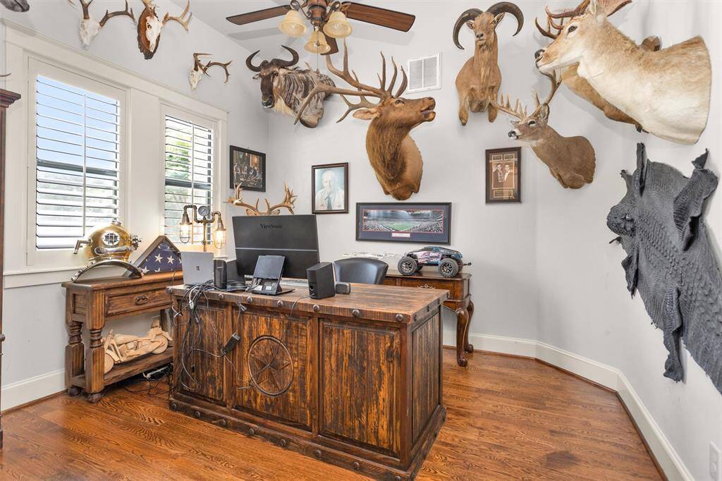 A dedicated home office or study with elegant French doors and custom touches—ideal for working remotely or a quiet reading space.