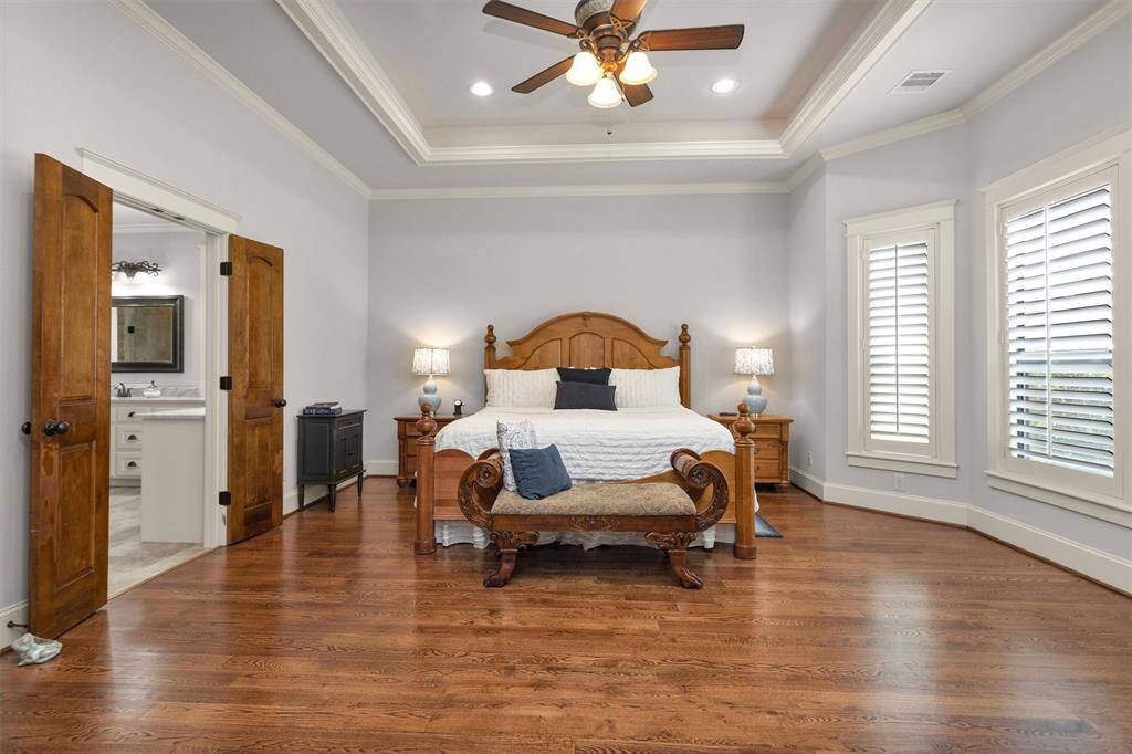 Retreat to your spacious primary suite featuring wood floors and plenty of room for a sitting area or reading nook—your private sanctuary after a long day.