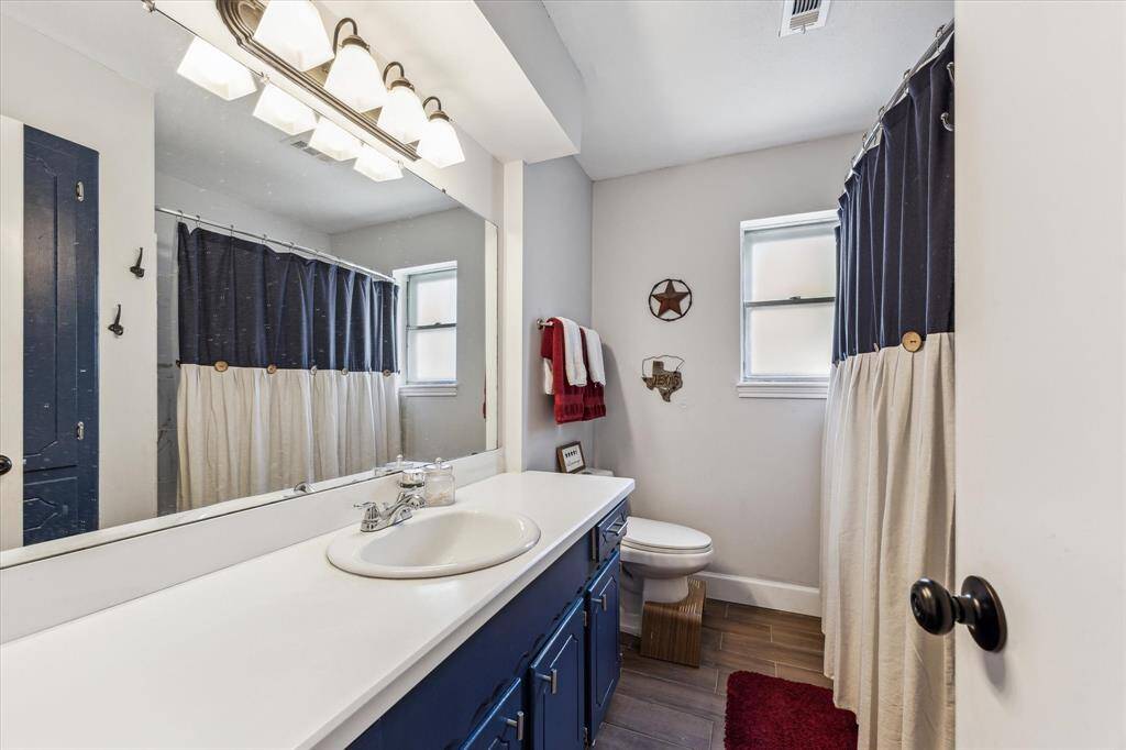 The primary bath offers a shower/tub combo, ample storage, and a convenient linen closet.