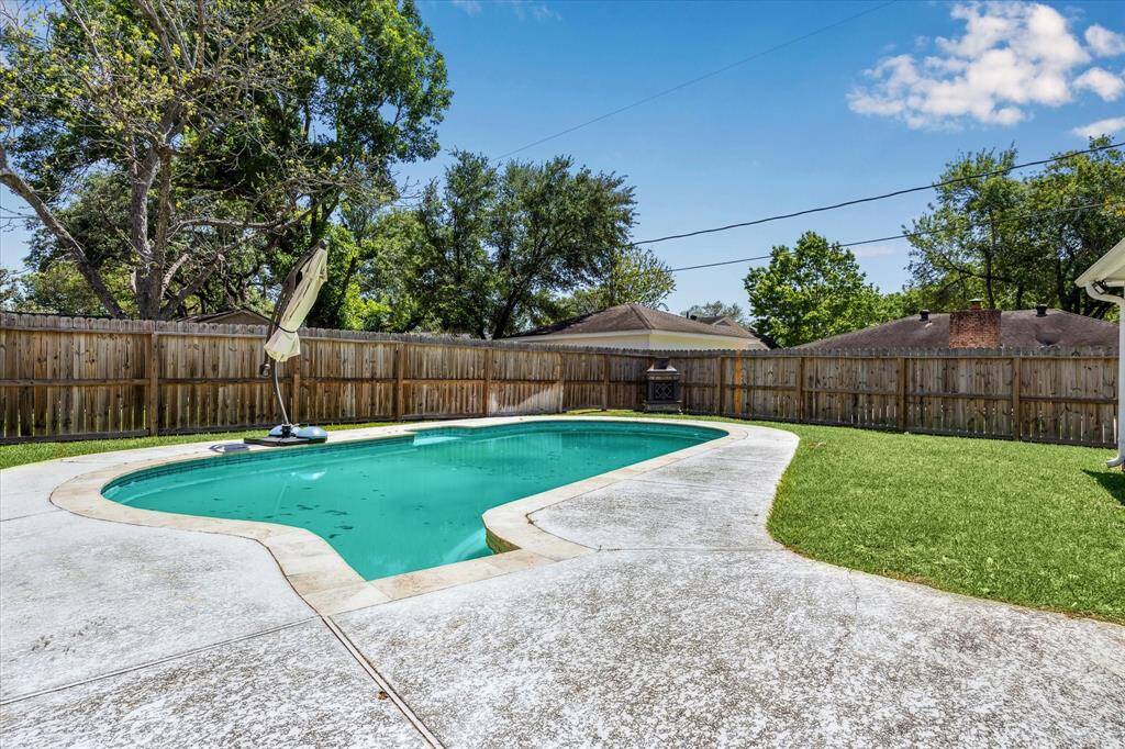 Dive into relaxation with this charming kidney-shaped pool, set in a spacious backyard that's perfect for entertaining and unwinding in style!