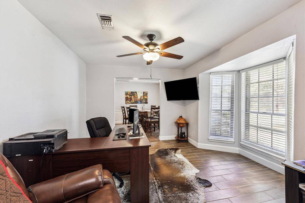 Originally a den, this versatile space is now a home office but can effortlessly transform into a home gym, playroom, TV room, or library. Endless possibilities await!