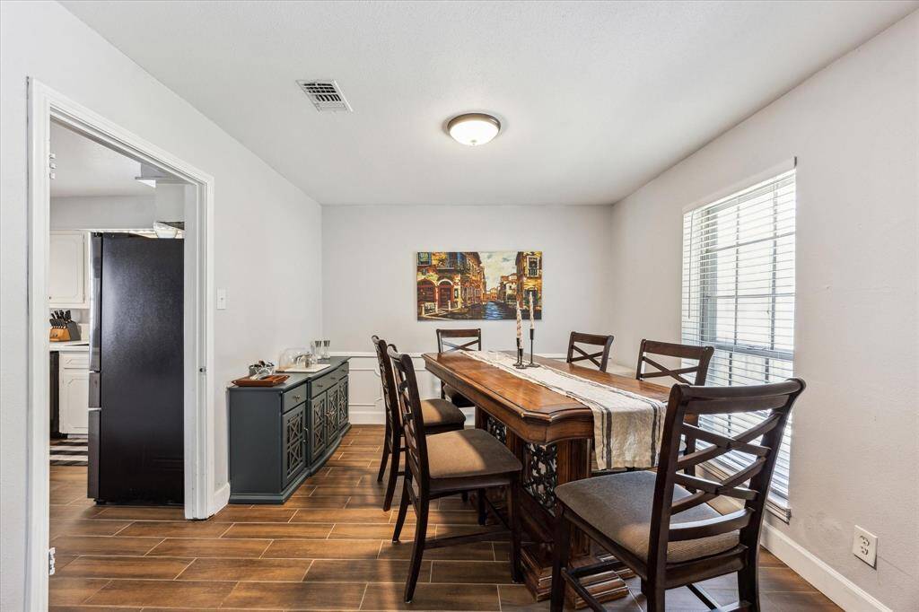 The formal dining room seamlessly connects to both the kitchen and the den.