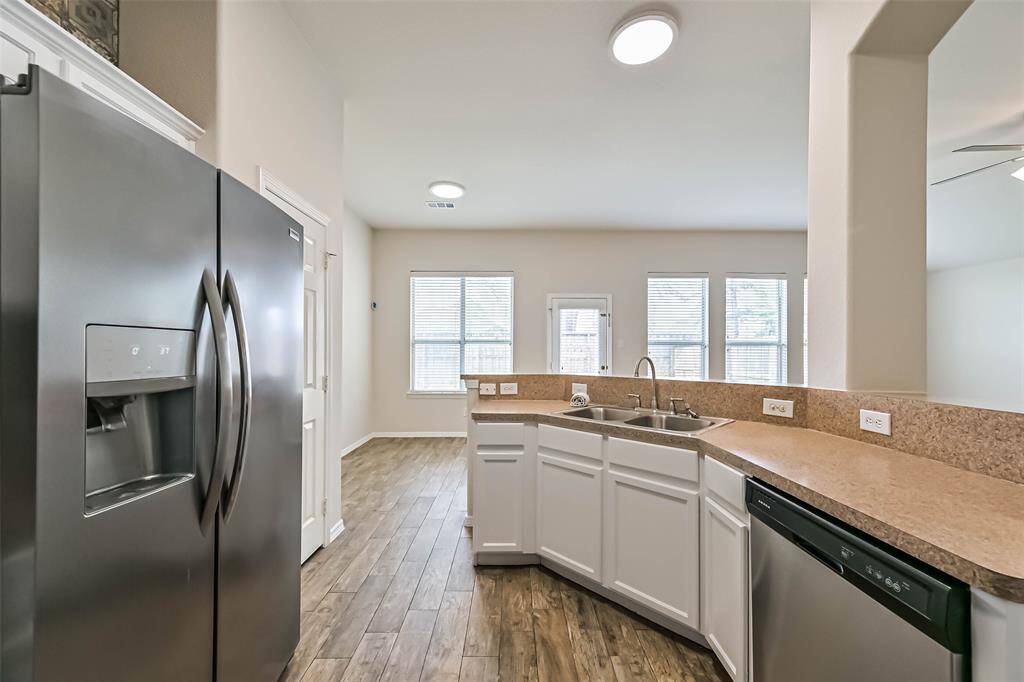 Chef's eat-in kitchen features stainless steel appliances and a breakfast bar perfect for entertaining