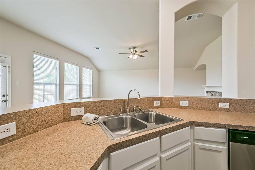 Chef's eat-in kitchen features stainless steel appliances and a breakfast bar perfect for entertaining