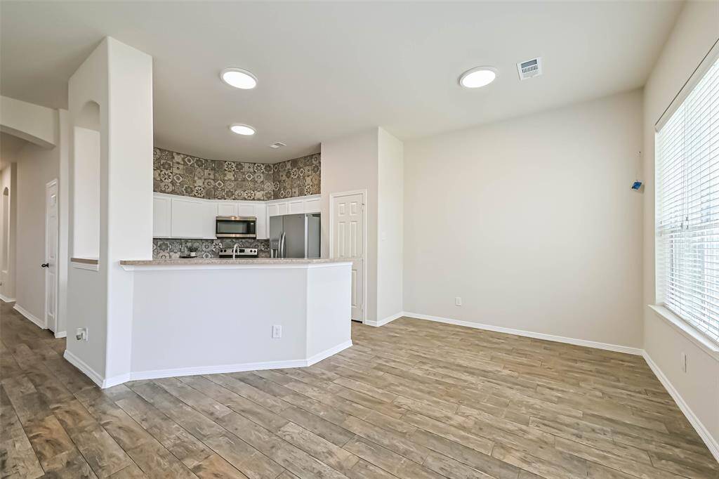 Chef's eat-in kitchen features stainless steel appliances and a breakfast bar perfect for entertaining