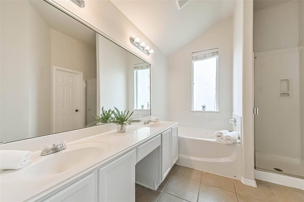 Primary en-suite bath features a walk-in shower, soaking tub, double sinks and a walk-in closet