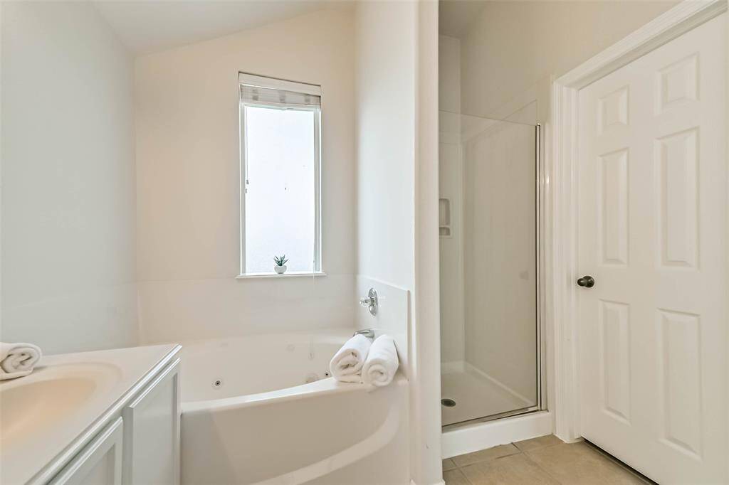 Primary en-suite bath features a walk-in shower, soaking tub, double sinks and a walk-in closet