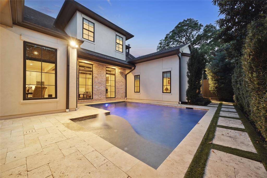 The stunning pool is the centerpiece of the backyard, surrounded by lush landscaping and designed for both relaxation and privacy. Tumbled travertine decking adds a touch of elegance, while the private setting ensures a serene and peaceful retreat.