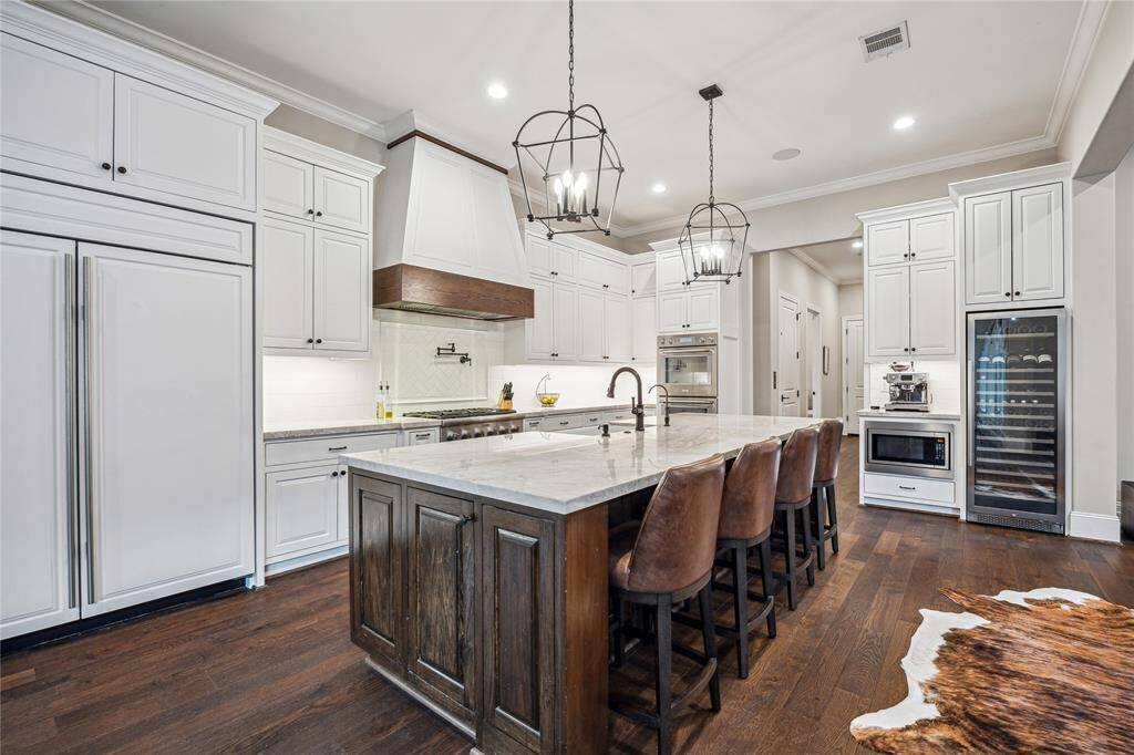 This well-appointed kitchen also includes a built-in wine fridge and microwave, adding convenience and style to the space.