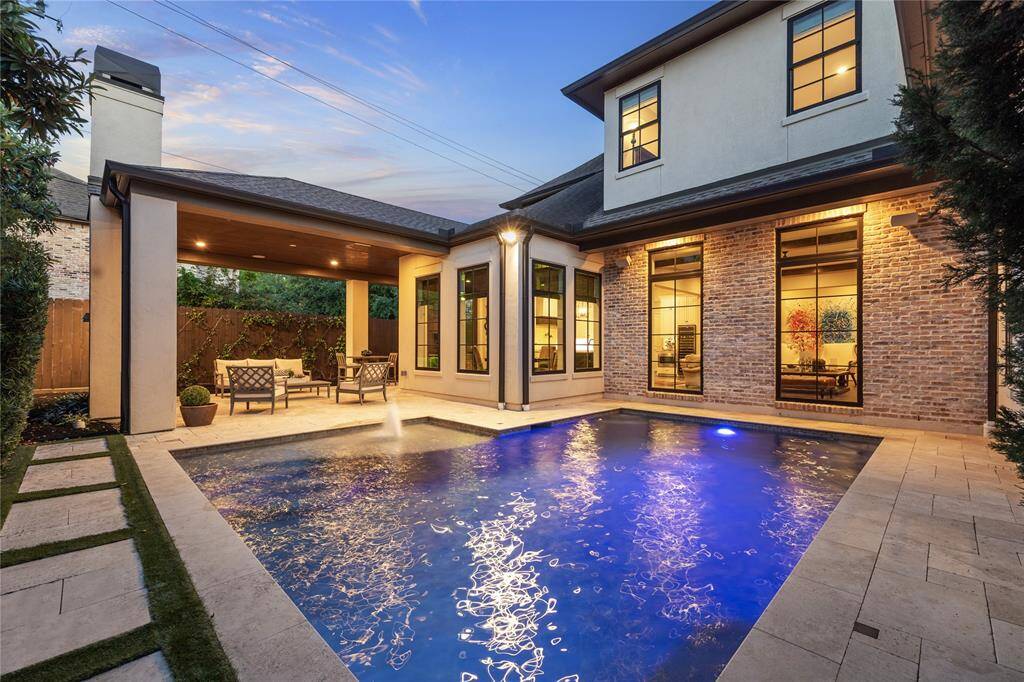 The stunning pool is the centerpiece of the backyard, surrounded by lush landscaping and designed for both relaxation and privacy. Tumbled travertine decking adds a touch of elegance, while the private setting ensures a serene and peaceful retreat—perfect for unwinding or entertaining.