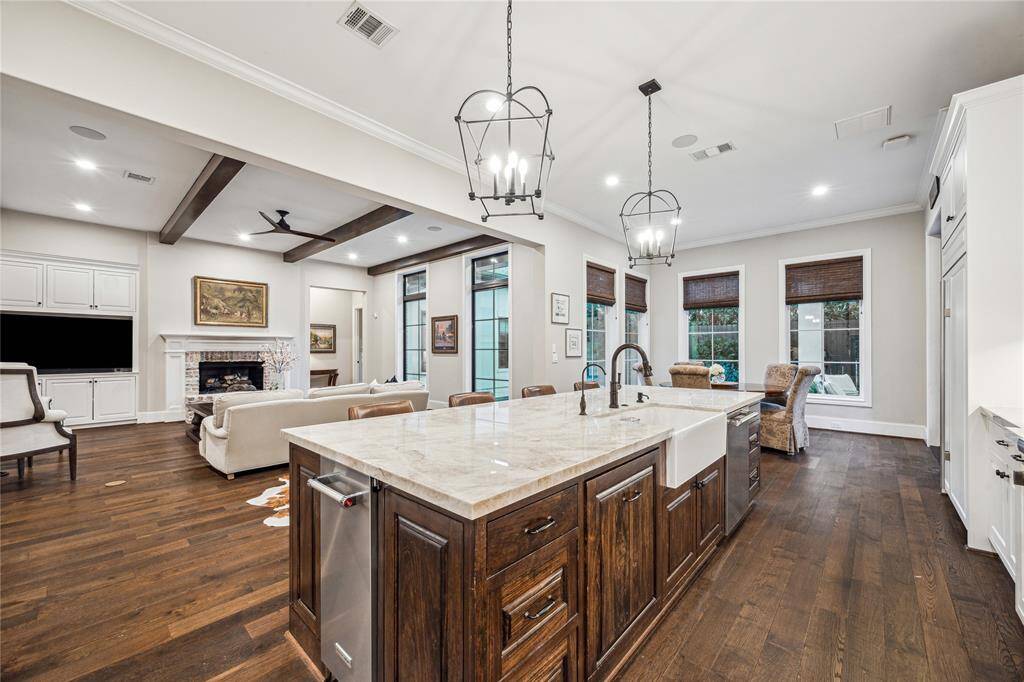 The large island features a KitchenAid ice maker, pot filler, and apron sink with a water filtration system, making this space ideal for cooking and entertaining.