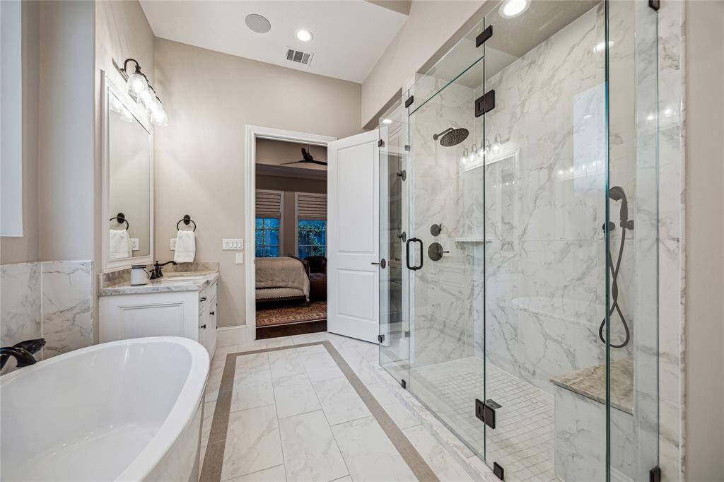 The water closet includes a Toto washlet toilet, and the custom walk-in closet offers extensive storage with built-ins all the way to the ceiling, plus a full-size peninsula and wide makeup vanity.