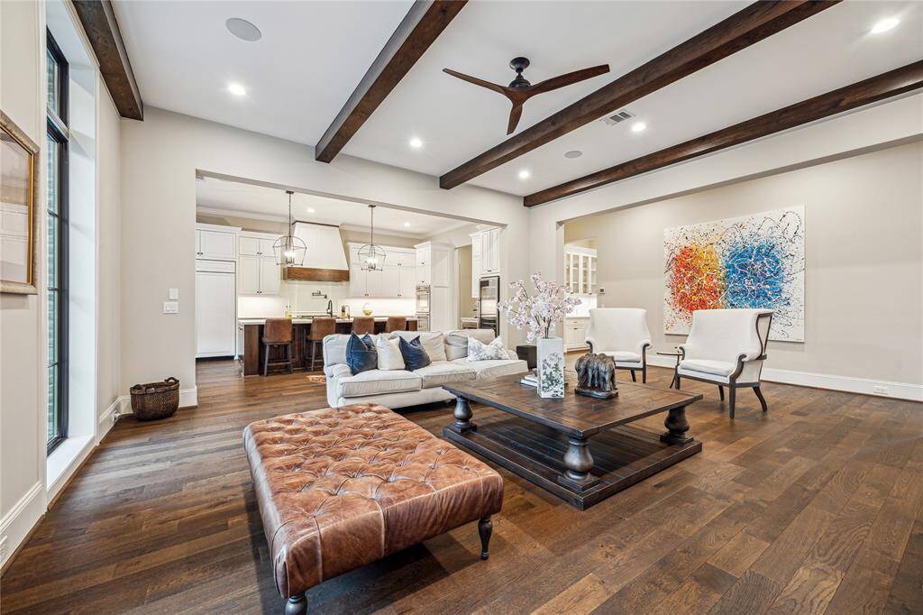 The entire downstairs is adorned with beautiful wood floors, adding warmth and continuity throughout. The open layout seamlessly connects the family room to the kitchen, creating a perfect flow for both everyday living and entertaining.