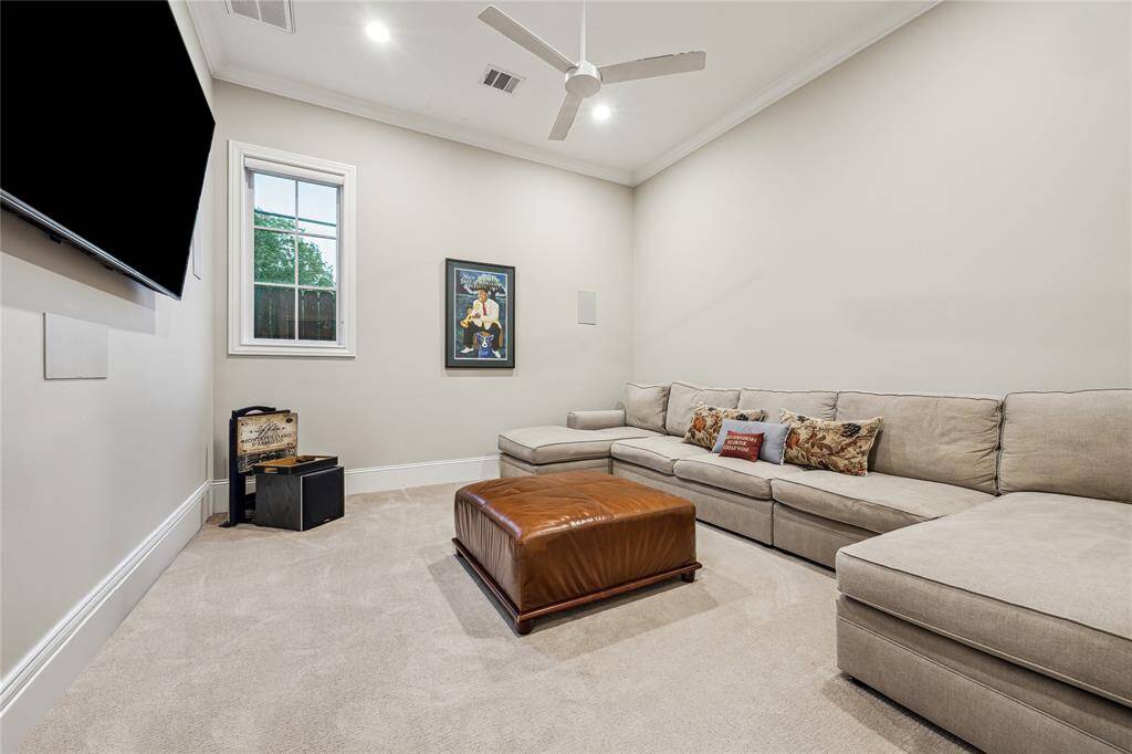 The media room, located downstairs on the opposite side of the house near the mudroom and elevator, is designed for ultimate relaxation and entertainment. It features in-wall speakers that fill the room with sound and plush carpeting that adds warmth and comfort.