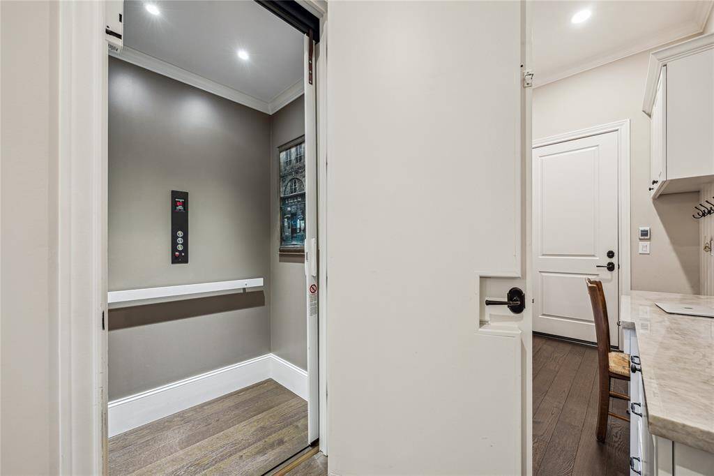 The elevator is conveniently located near the kitchen and mudroom, this elevator provides easy access to all levels of the home. It offers both comfort and practicality.