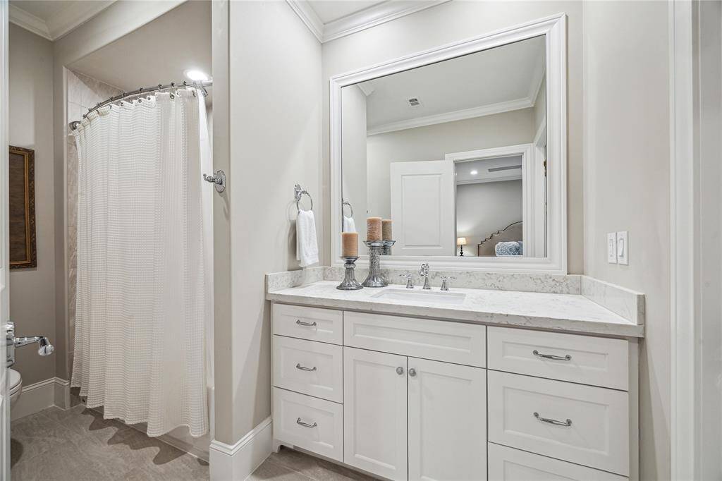 This charming bathroom features a tub/shower combo, offering a relaxing space for baths or quick showers. With sleek countertops, custom cabinetry, and modern fixtures.