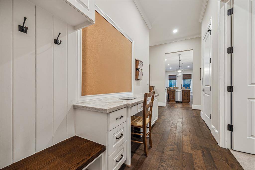 Mud room and built-in desk area are located near the garage entry and kitchen, the mud room offers a practical space with built-in storage to keep things organized. A convenient built-in desk area provides an ideal spot for managing household tasks.