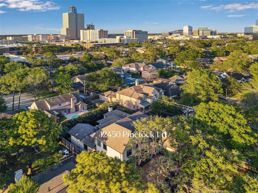 From above, the home at 12450 Pinerock showcases its stunning architecture and spacious lot, nestled in a private, serene setting. Located in close proximity to shopping, dining, and the vibrant City Centre.