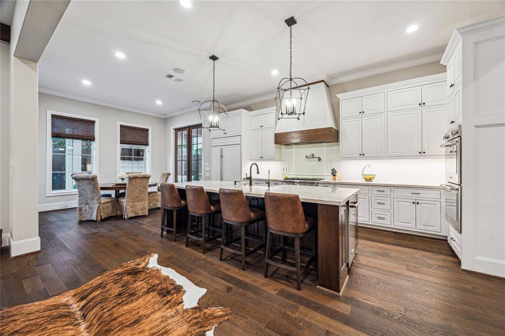 A chef’s dream, this gourmet kitchen is equipped with high-end Thermador appliances, including a 36" 6-burner gas range and double ovens.