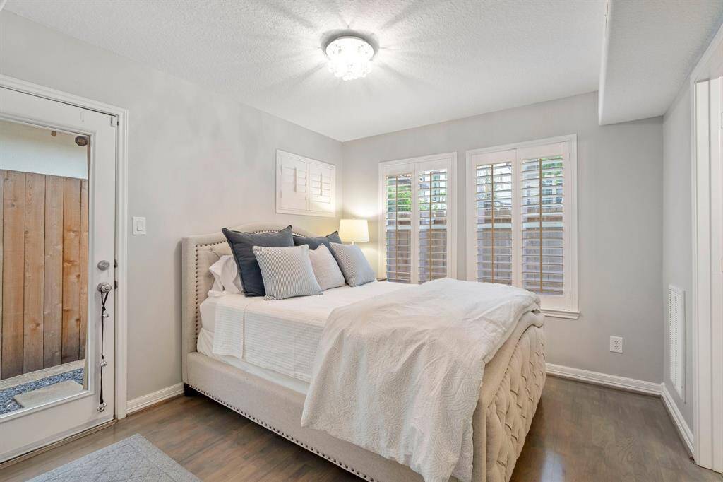 First floor bedroom with en-suite bath and door leading to yard.